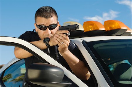 Police Officer Aiming Handgun Stock Photo - Premium Royalty-Free, Code: 693-06019834