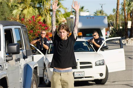 Police Officer Arresting Young Man Stock Photo - Premium Royalty-Free, Code: 693-06019835