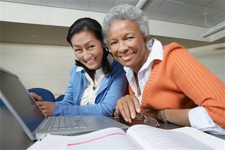 female teacher portrait students - Two mature female students using laptop in lecture theatre, portrait Stock Photo - Premium Royalty-Free, Code: 693-06019971