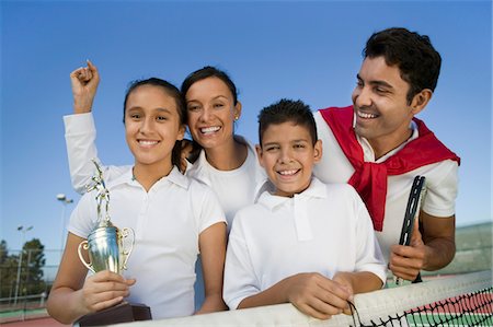 simsearch:693-06013834,k - Tennis Family at net on tennis court, daughter holding trophy, portrait Stock Photo - Premium Royalty-Free, Code: 693-06013836