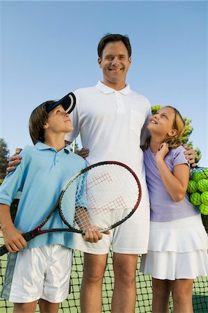 simsearch:693-06013834,k - Father with Son and Daughter by net on Tennis Court, portrait, front view Stock Photo - Premium Royalty-Free, Code: 693-06013890