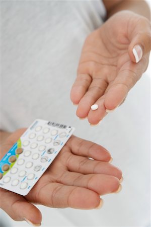 sick black woman - Close-up of woman's hands holding pills Stock Photo - Premium Royalty-Free, Code: 693-06020014