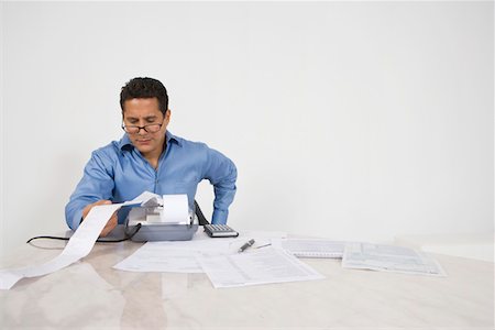 Man Calculating Finances Stock Photo - Premium Royalty-Free, Code: 693-06020055