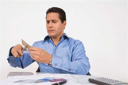 simsearch:693-06021323,k - Man Cutting up a Credit Card Stock Photo - Premium Royalty-Free, Code: 693-06020050