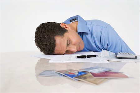simsearch:693-06021323,k - Man Exhausted from Paying Bills Stock Photo - Premium Royalty-Free, Code: 693-06020052