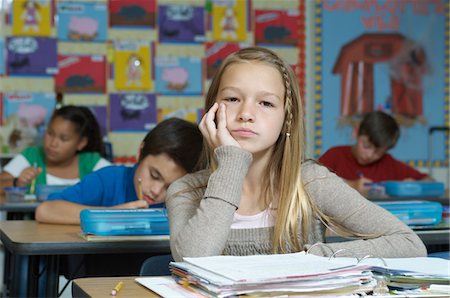 Serious schoolgirl  sitting and leaning Stock Photo - Premium Royalty-Free, Code: 693-06020463