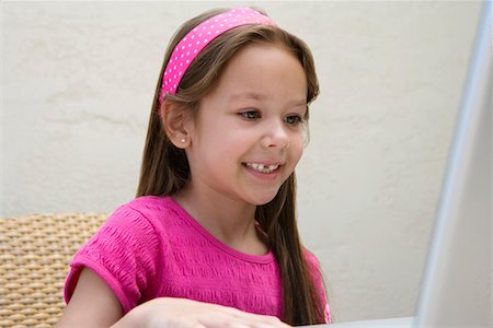 Little Girl Using a Laptop Stock Photo - Premium Royalty-Free, Code: 693-06020592