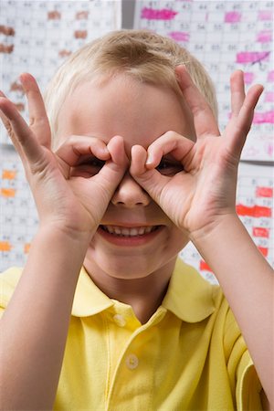 preteen eyes - Little Boy Making Binoculars with His Hands Stock Photo - Premium Royalty-Free, Code: 693-06020663