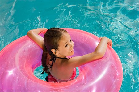 pictures girl swimming to colour - Girl Inside Pink Float Tube in Pool Stock Photo - Premium Royalty-Free, Code: 693-06020742