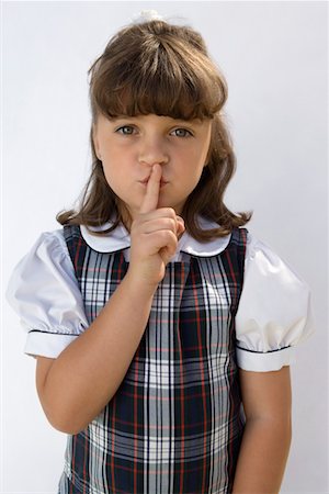 shhh - Elementary Student with Finger on Lips Stock Photo - Premium Royalty-Free, Code: 693-06020772