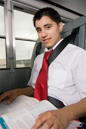 Teenage Boy Reading Textbook on Bus Stock Photo - Premium Royalty-Free, Code: 693-06020839