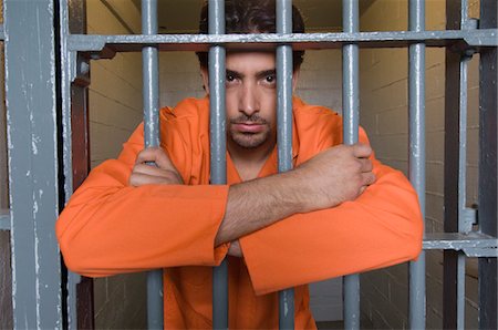 Portrait of prisoner behind bars Stock Photo - Premium Royalty-Free, Code: 693-06020901