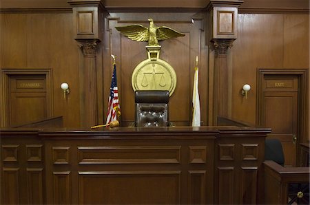 Legal scales behind judges chair in court Stock Photo - Premium Royalty-Free, Code: 693-06020926