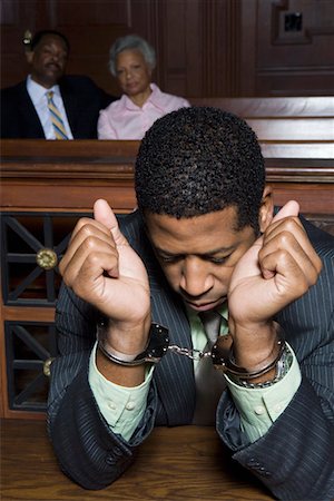 Criminal sitting in court Stock Photo - Premium Royalty-Free, Code: 693-06020957