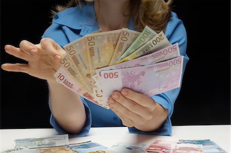 Woman Counting Money Stock Photo - Premium Royalty-Free, Code: 693-06021352