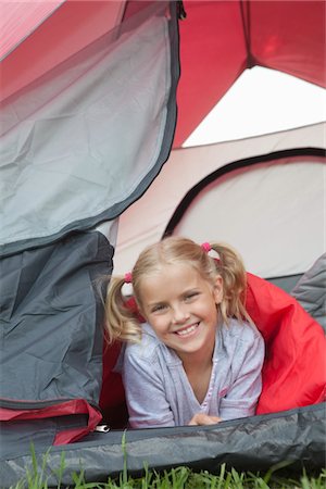 preteen girl pigtails - Girl smiles from tent Stock Photo - Premium Royalty-Free, Code: 693-06021494