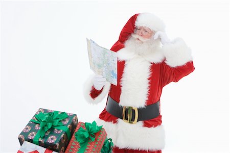 Santa Claus reading map Stock Photo - Premium Royalty-Free, Code: 693-06021807