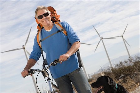 dog bicycle - Senior man with bicycle near wind farm Stock Photo - Premium Royalty-Free, Code: 693-06021952