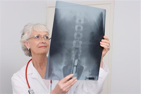 evidence - Senior medical practitioner examines xray Stock Photo - Premium Royalty-Free, Code: 693-06022025