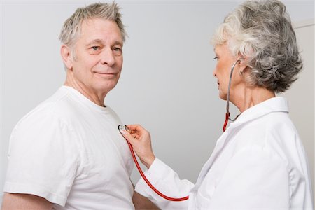 senior woman and doctor and two people - Senior medical practitioner examines man with stethoscope Stock Photo - Premium Royalty-Free, Code: 693-06022029