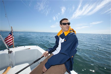 sailboat  ocean - Young man sailing Stock Photo - Premium Royalty-Free, Code: 693-06022158