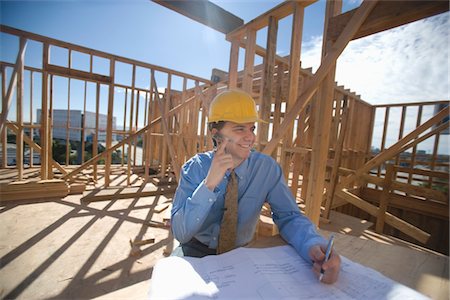 Site manager with building plans Stock Photo - Premium Royalty-Free, Code: 693-06022184