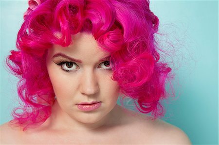 simsearch:693-06323962,k - Portrait of a pink hair woman over colored background Stock Photo - Premium Royalty-Free, Code: 693-06120746