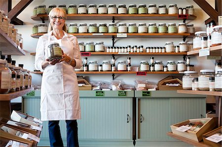 shelves at a grocery store - Portrait of a happy senior merchant standing with spice jar in store Stock Photo - Premium Royalty-Free, Code: 693-06120780