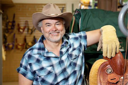 Portrait of a happy mature cowboy in feed store Stock Photo - Premium Royalty-Free, Code: 693-06121158