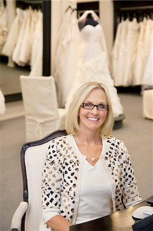 simsearch:693-05794538,k - Portrait of a happy woman sitting on chair in bridal store Stock Photo - Premium Royalty-Free, Code: 693-06121263