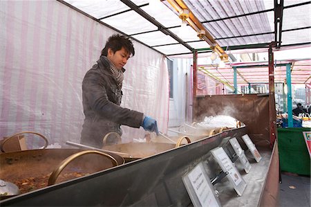 Young Asian man cooking Thai food Stock Photo - Premium Royalty-Free, Code: 693-06121305