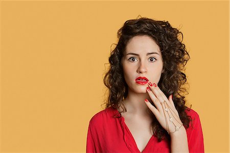 Portrait of a shocked woman over colored background Stock Photo - Premium Royalty-Free, Code: 693-06121346