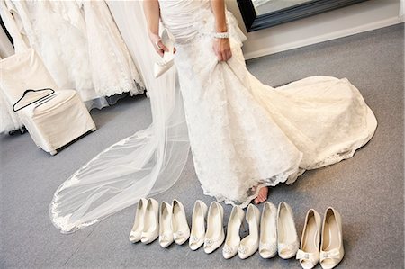 simsearch:693-05794538,k - Low section of young woman standing with variety of footwear in bridal boutique Stock Photo - Premium Royalty-Free, Code: 693-06324069