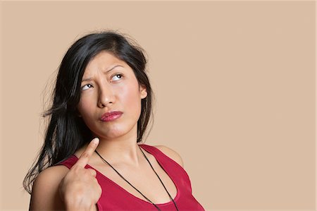 simsearch:693-06323962,k - Young woman pointing over colored background Stock Photo - Premium Royalty-Free, Code: 693-06324144