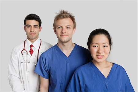 simsearch:693-06324311,k - Portrait of diverse medical team standing over gray background Stock Photo - Premium Royalty-Free, Code: 693-06324247