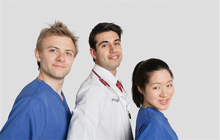 simsearch:693-06324311,k - Portrait of multi ethnic medical team over gray background Stock Photo - Premium Royalty-Free, Code: 693-06324243