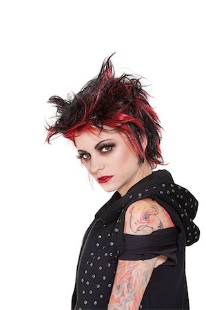 punk - Portrait of punk woman showing attitude over white background Stock Photo - Premium Royalty-Free, Code: 693-06324397