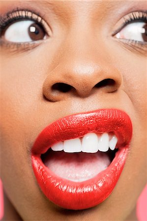 red lips - Cropped image of shocked young woman with red lips looking to her side Stock Photo - Premium Royalty-Free, Code: 693-06324648