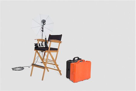 empty suitcase - Director's chair and reflector umbrella with suitcase in studio Stock Photo - Premium Royalty-Free, Code: 693-06324852