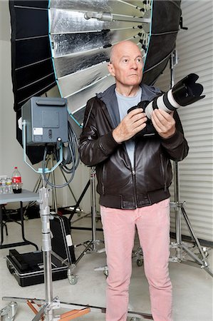 photographer (male) - Front view of senior man with camera in photographer's studio Stock Photo - Premium Royalty-Free, Code: 693-06324865