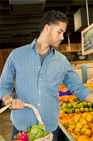 fruit stand basket - Handsome young man shopping in market Foto de stock - Sin royalties Premium, Código: 693-06324914