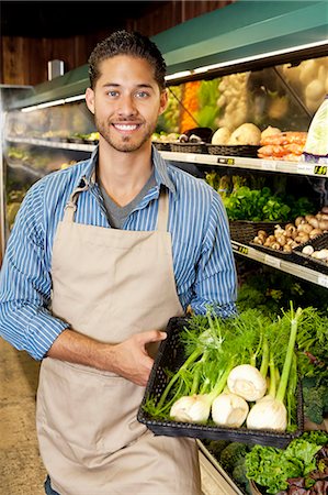 sales associate (male) - Portrait of a happy man with basket full of green onion in supermarket Stock Photo - Premium Royalty-Free, Code: 693-06324944