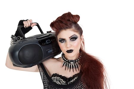 punk - Portrait of punk woman holding boom box on shoulder over white background Stock Photo - Premium Royalty-Free, Code: 693-06325016