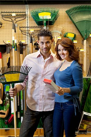 economy tool - Portrait of young couple with gardening claw in store Stock Photo - Premium Royalty-Free, Code: 693-06325090