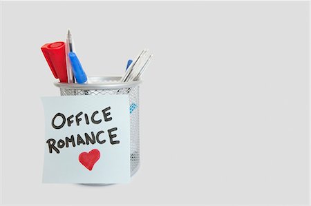 Conceptual image of sticky notepaper with heart shape depicting office romance Stock Photo - Premium Royalty-Free, Code: 693-06325165