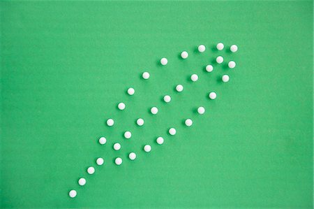 Close-up view of push pins forming leaf over colored background Stock Photo - Premium Royalty-Free, Code: 693-06325206