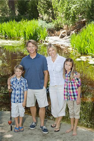 preteen girl lake - Full length portrait of couple with children standing against lake Stock Photo - Premium Royalty-Free, Code: 693-06378775