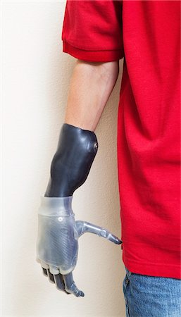 disable - Cropped image of man with prosthetic hand over gray background Stock Photo - Premium Royalty-Free, Code: 693-06378802