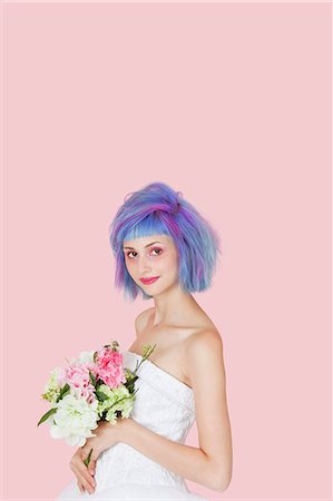 simsearch:693-06323962,k - Portrait of beautiful young woman in wedding dress with dyed hair against pink background Stock Photo - Premium Royalty-Free, Code: 693-06378868