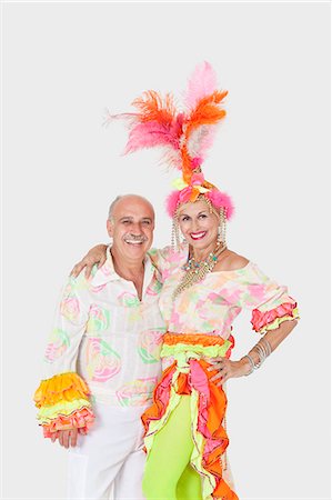 Portrait of happy senior dance couple in Brazilian outfits over gray background Foto de stock - Sin royalties Premium, Código: 693-06378877